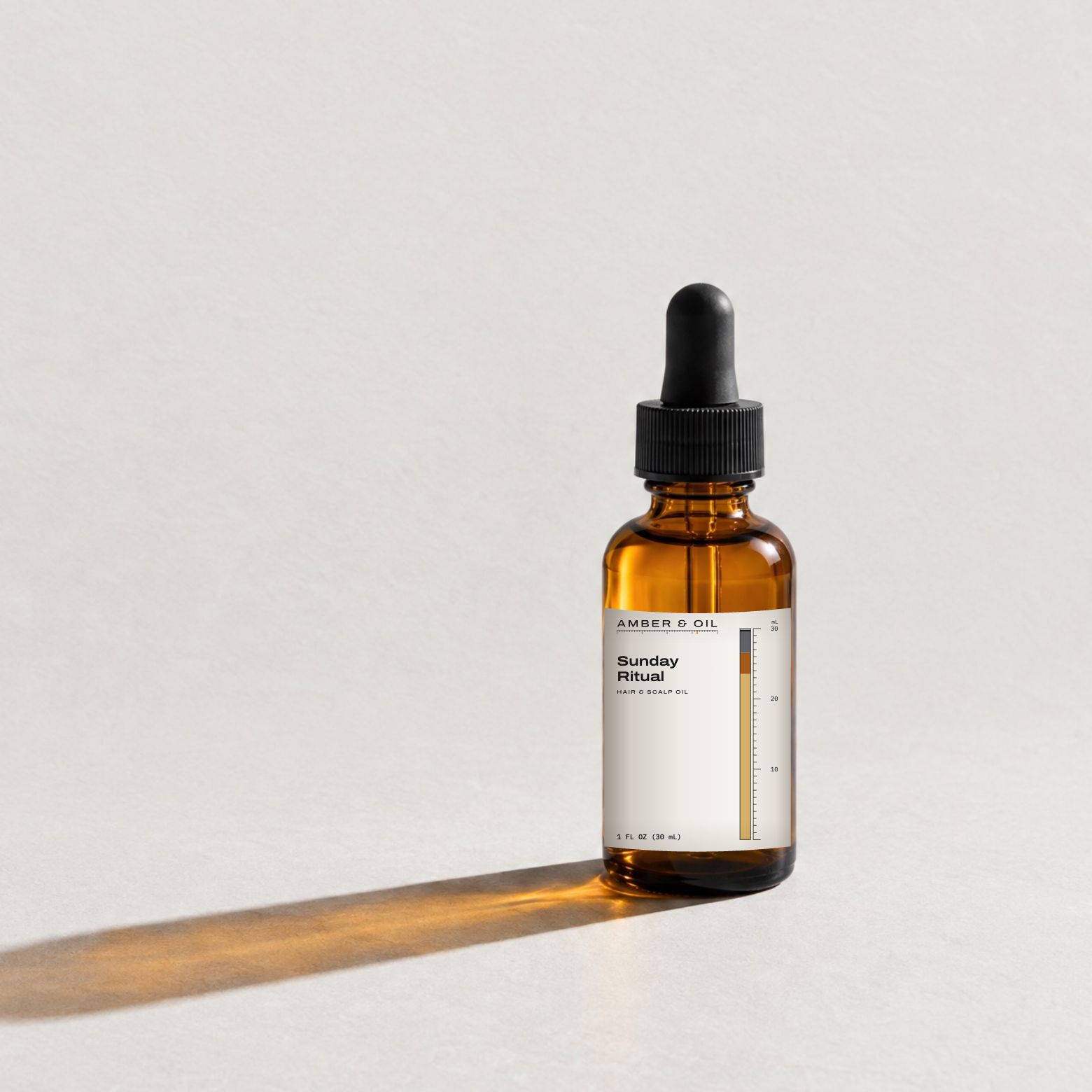 Sunday Ritual in the 1 oz bottle: amber glass with a black dropper and a white label carrying the Amber & Oil logo, the blend name and its ratio bar.